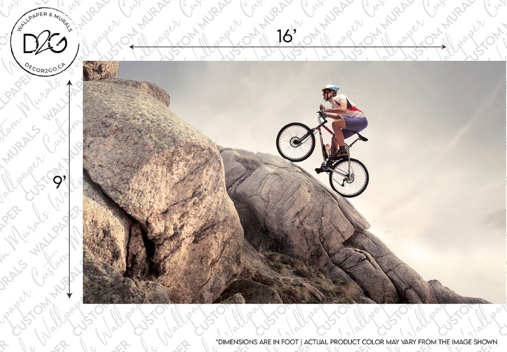 A mountain biker performs a daring jump over a large rocky outcrop under a cloudy sky. The Decor2Go Wallpaper Mural is mid-air, and the rider, targeted at extreme sports lovers, is focused and wearing a.