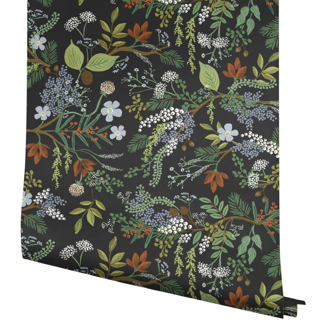 A roll of Black Juniper Forest Wallpaper (60 SqFt) by York Wallcoverings showcases a dark background with detailed, colorful leaves, flowers, and berries—ideal for those who love nature-inspired wallpaper designs.
