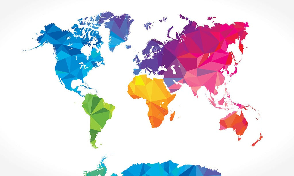 A colorful, geometric world map wallpaper mural with continents depicted in various bright colors against a white background, creating a modern and abstract geographical representation with an embossed texture by Decor2Go Wallpaper Mural.