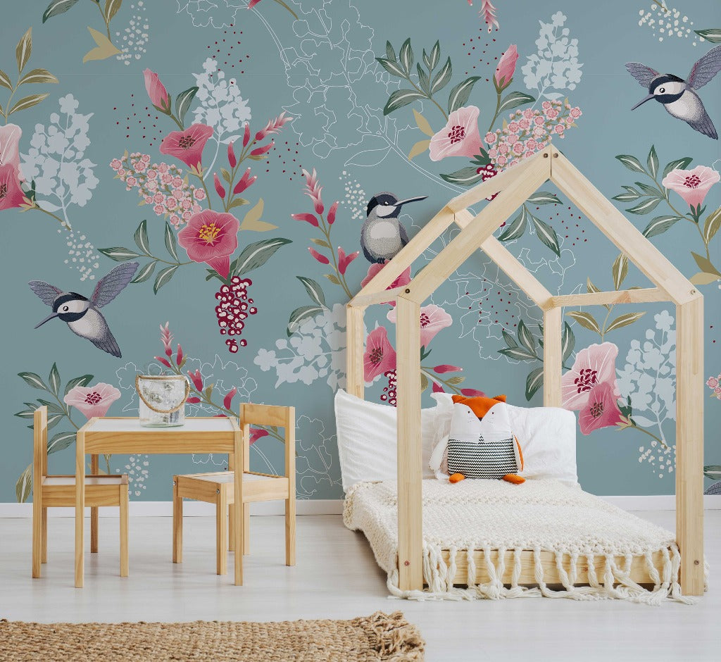 A cozy children's bedroom featuring a house-shaped wooden bed frame with a white knit blanket, a small wooden table with chairs, and walls decorated with an artistic Decor2Go Wallpaper Mural.
