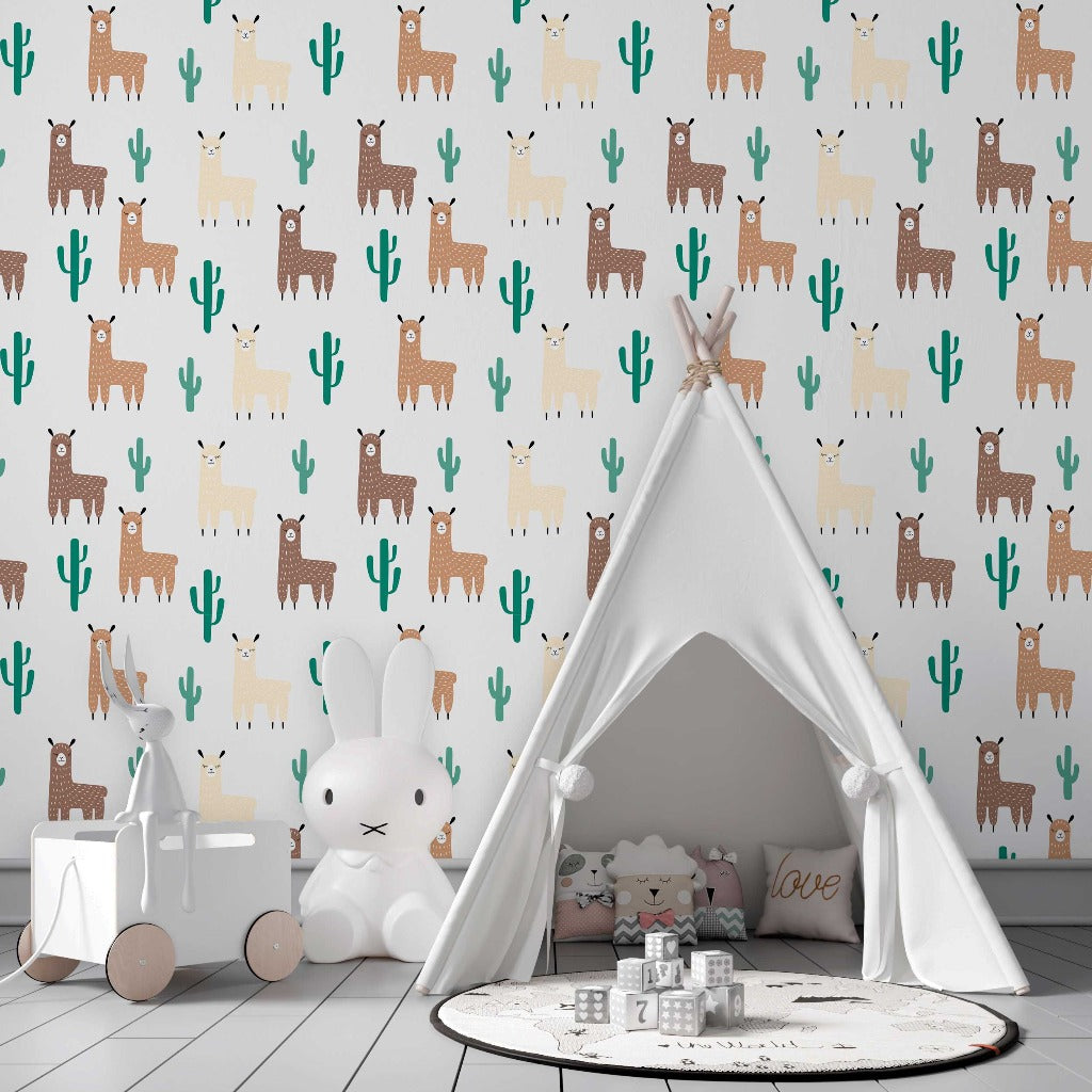 A children's playroom featuring a white teepee tent, a round rug with star prints, a white rabbit-shaped chair, and toys around. The Decor2Go Wallpaper Mural Llama and Cactus Pattern Wallpaper Mural lines the walls.