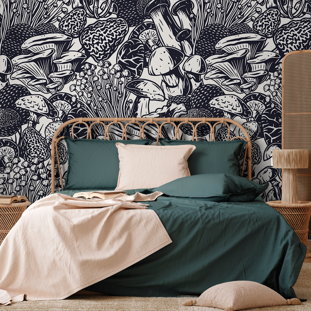 A cozy bedroom with a rattan bed frame, green and cream bedding, against a feature wall with a detailed black and white botanical Decor2Go Wallpaper Mural.