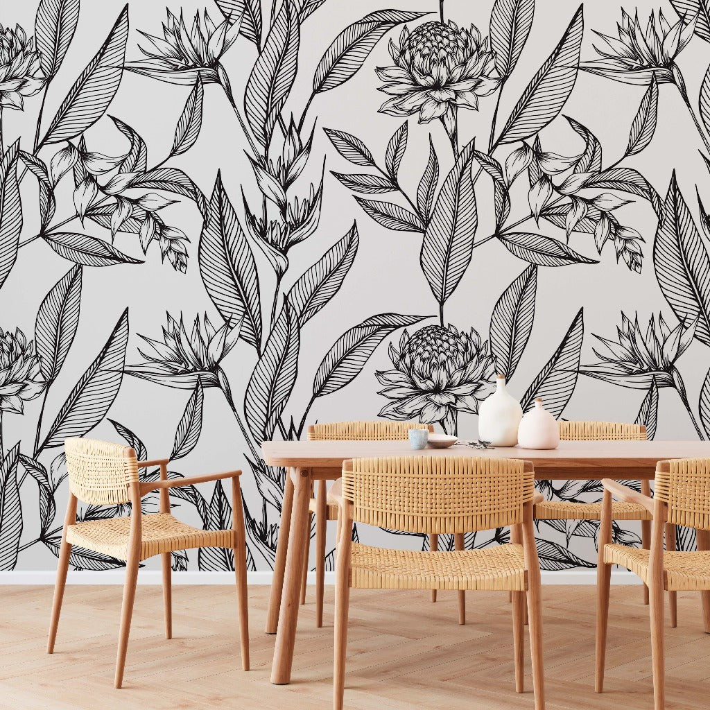A modern dining area featuring a wooden table with simple chairs accented by woven backs, set against a wall adorned with large, artistic Decor2Go Wallpaper Mural.