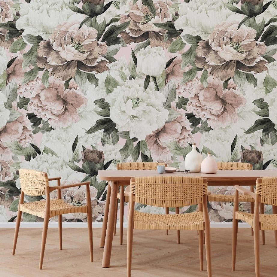 A stylish dining area with a Decor2Go Wallpaper Mural featuring large pink and white flowers. A wooden table with four wicker chairs is set with minimalistic decor.