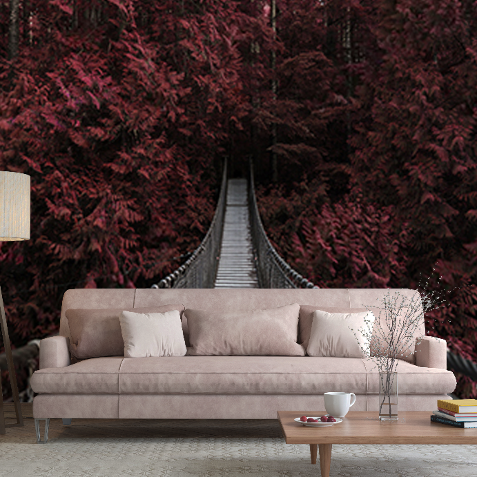 A surreal living room with a soft pink sofa and a wooden coffee table, set against a large, vivid backdrop of Decor2Go Wallpaper Mural, disappearing into lush autumn colors.