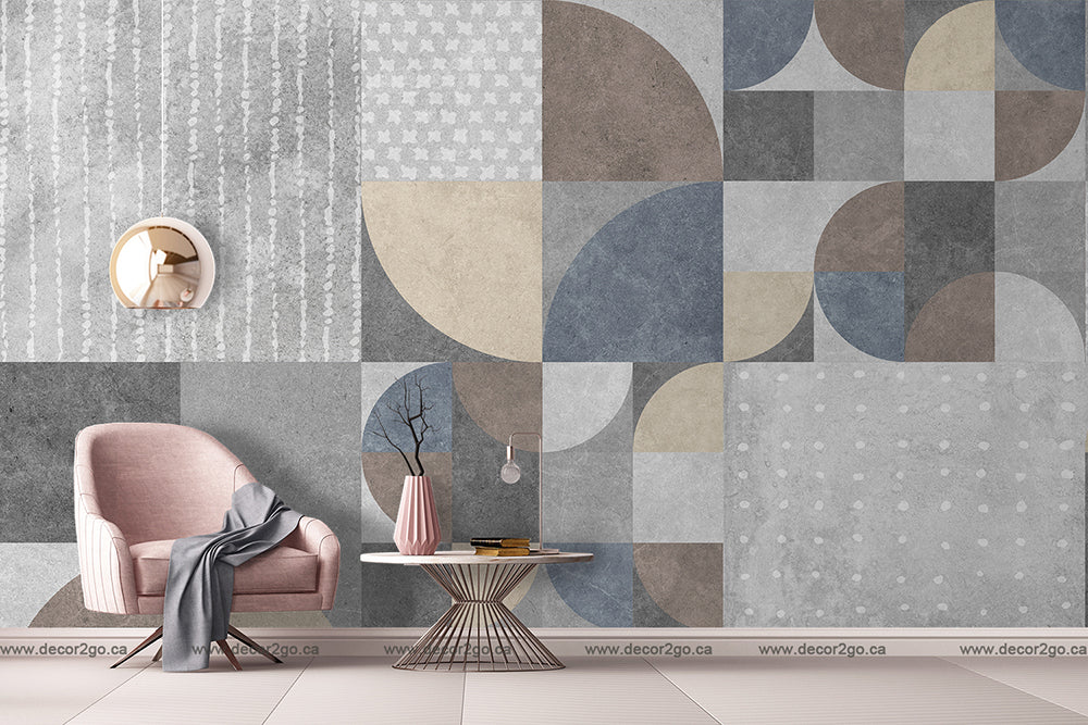 A modern living room featuring a pink armchair, a round white coffee table with books and decorative items, a Decor2Go Wallpaper Mural, and a minimalist circular mirror.