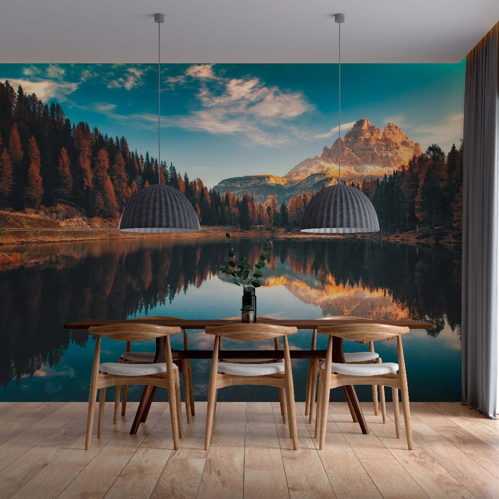 A modern dining room with sleek wooden furniture, set against a Decor2Go Tranquil Lake Wallpaper Mural of a tranquil lake surrounded by autumn-tinted trees.