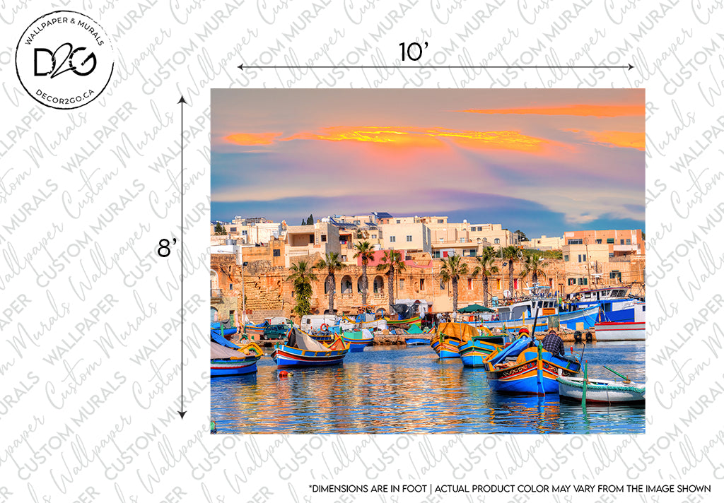 Sunset over a Mediterranean seaside town in Malta with colorful boats moored in the harbor and traditional buildings showcasing unique architectural design in the background. The sky is vibrant with shades of yellow and orange captured beautifully in the Decor2Go Wallpaper Mural titled Forever Malta.