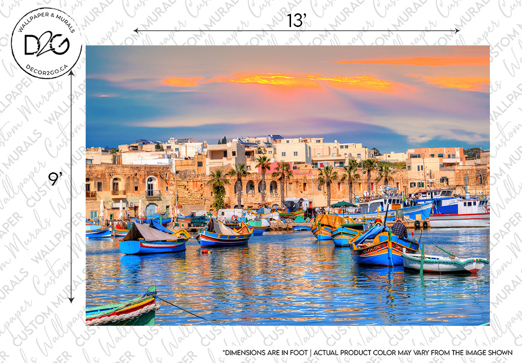 A scenic view of a harbor with colorful traditional Maltese boats (luzzus) floating on blue water, backed by historic beige stone buildings under a sunset sky with pink and orange hues, perfect for the Forever Malta Wallpaper Mural by Decor2Go Wallpaper Mural.