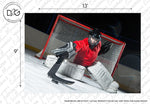 A Decor2Go Wallpaper Mural featuring a hockey goalie in red and black gear crouches in front of the net on the ice, ready to block a shot. Bright studio lighting highlights the player and the net. Watermarks and measurement marks are visible.