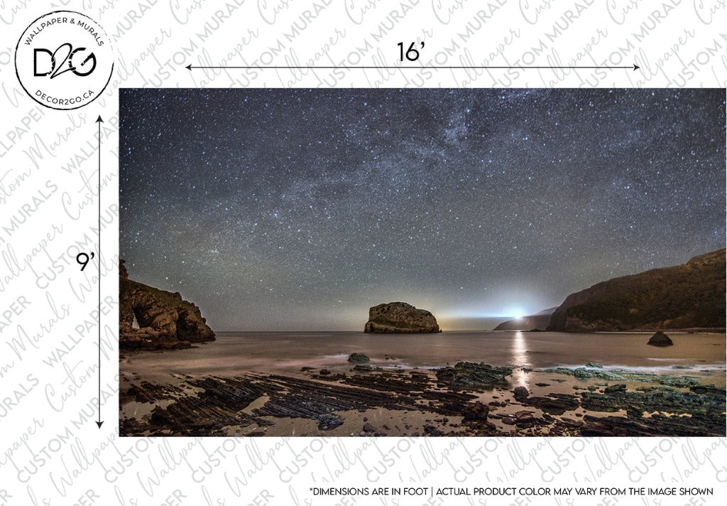 A serene night sky filled with stars above a calm sea, featuring a large rock formation in the water and gentle waves lapping at a sandy shore. A faint galactic glow is visible on the horizon. Get lost in the beauty with the Milky Way Galactic Coast Wallpaper Mural from Decor2Go Wallpaper Mural.