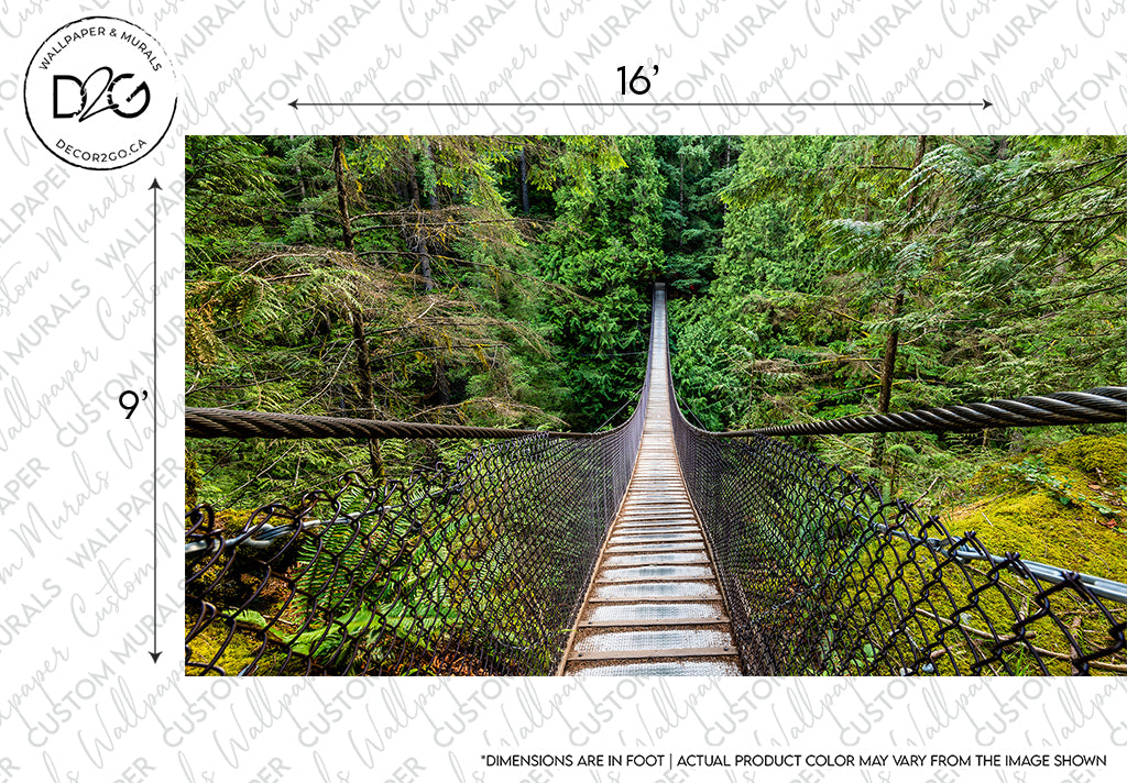A long, narrow Decor2Go Wallpaper Mural forest suspension bridge stretches over a lush valley, surrounded by tall evergreen trees. The bridge features a metallic mesh as side barriers and a wooden plank floor.
