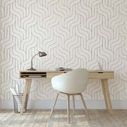 Home Office - A minimalist home office with a light wood desk and a cream chair, set against Decor2Go Wallpaper Mural with a wavy pattern, beside a large window illuminating the room.