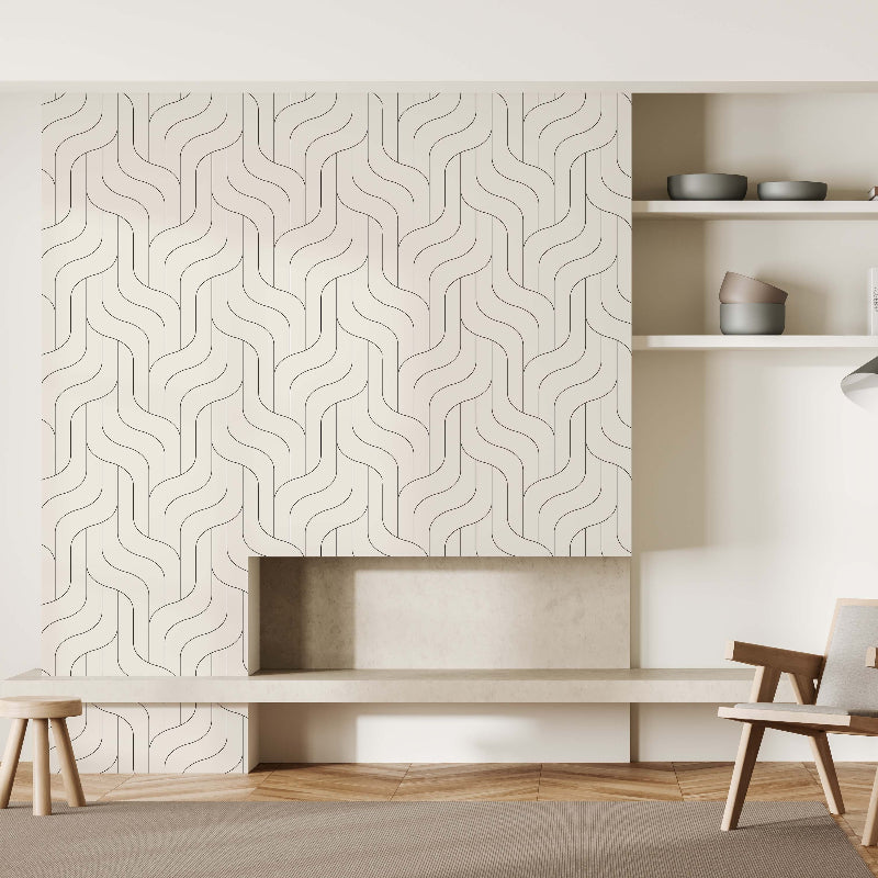 A minimalist living room boasts a dynamic Wavy Pattern Wallpaper Mural by Decor2Go, wooden floor, modern armchair, floor lamp, and open shelves. Neutral tones and simple décor create serenity. A small stool complements the low built-in bench.