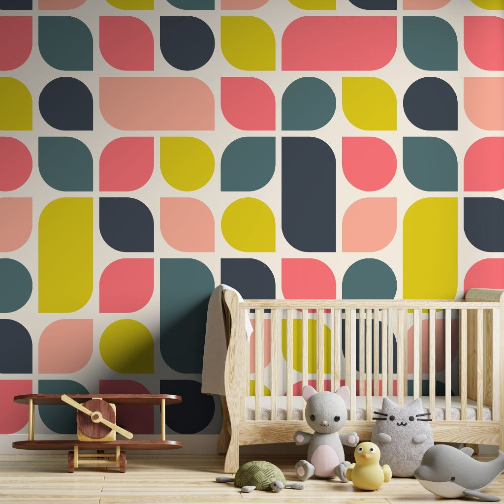 A cozy nursery with a wooden crib against Retro Abstract Geometry Wallpaper Mural from Decor2Go. Next to the crib, a wooden toy airplane and plush toys sit on a light wood floor.