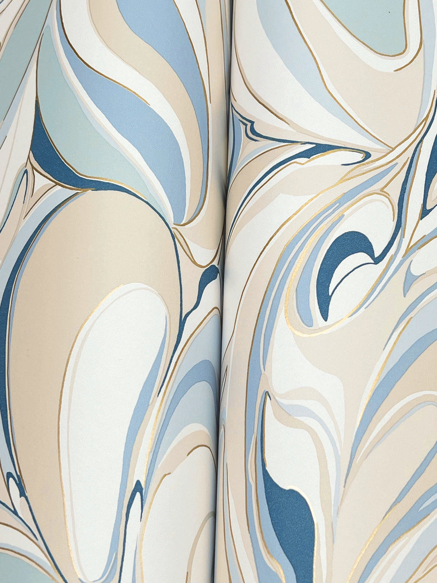 Achate Blue Wallpaper by York Wallcoverings features soft blue, cream, beige, and gold tones with fluid, marbled lines and metallic gold accents. This design covers 60 SqFt for an elegant, organic look with a subtle sheen.