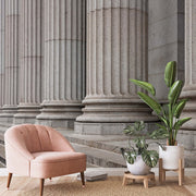 Pink chair and tropical plants with a realistic concrete pillars in the wallpaper