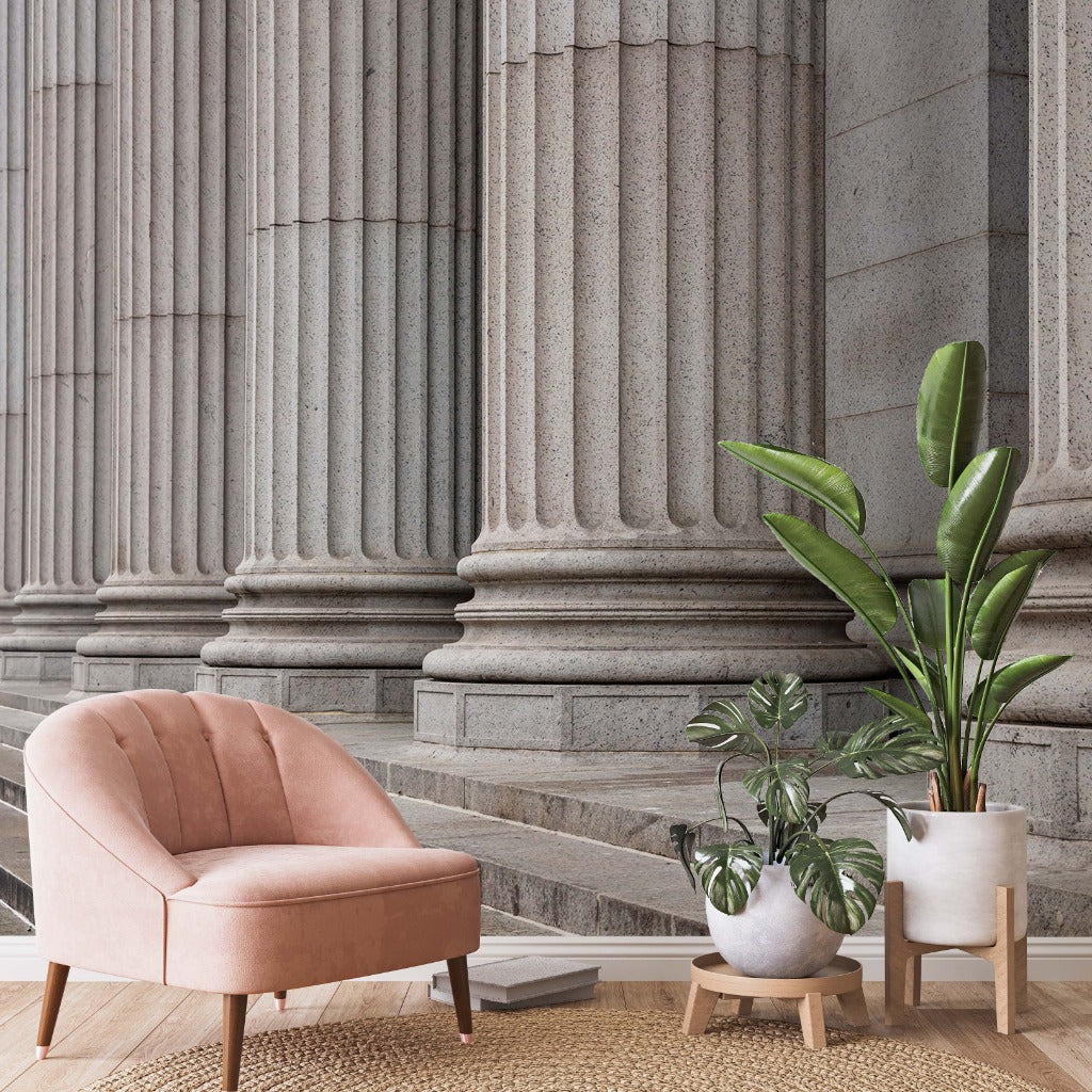 Pink chair and tropical plants with a realistic concrete pillars in the wallpaper 