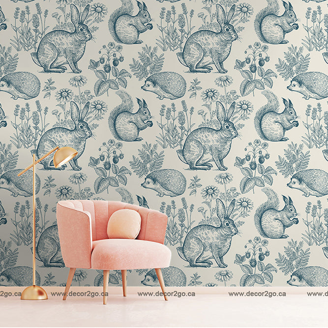 Pink chair with a wallpaper mural in blue with rabbits, plants, flowers, and squirrels 