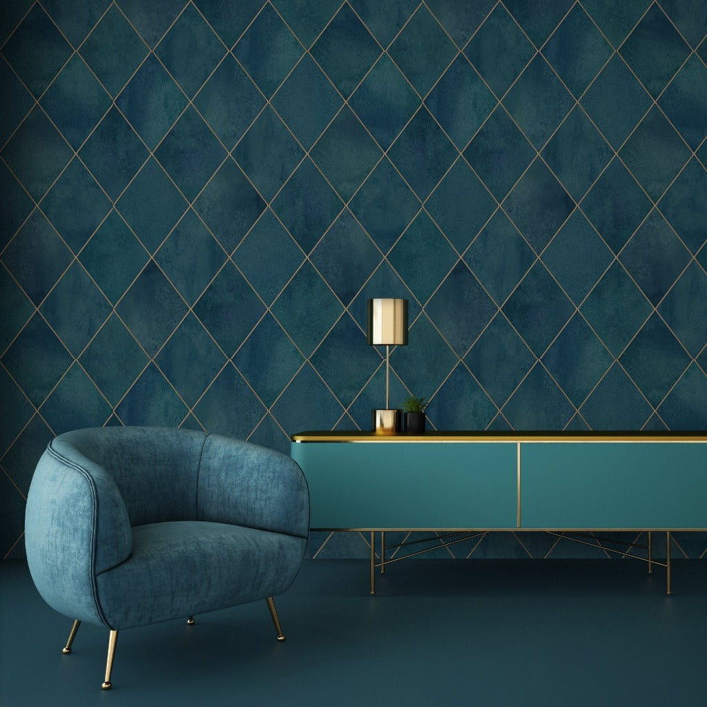 Elegant interior design featuring a plush blue armchair and a long teal console table against a textured dark blue wall with Decor2Go Wallpaper Mural. A stylish lamp and green plant adorn the table.
