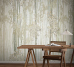 A wooden desk and chair face the Aspen Grove Beige Wallpaper Mural (2 Panels) by York Wallcoverings, featuring subtle tree-like patterns. A modern lamp with a pleated white shade rests on the desk, creating a minimalist, natural look.