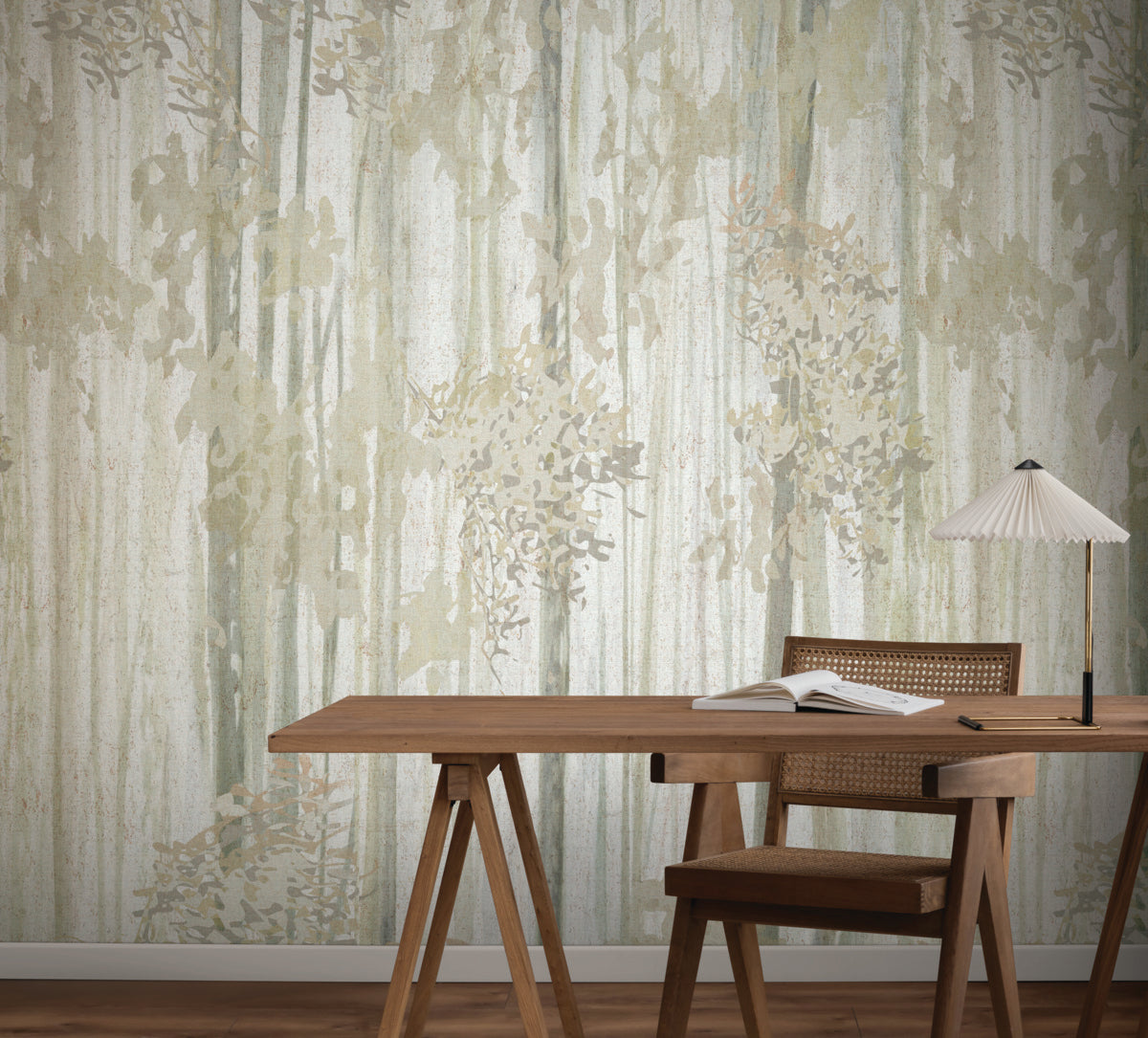 A wooden desk and chair face the Aspen Grove Beige Wallpaper Mural (2 Panels) by York Wallcoverings, featuring subtle tree-like patterns. A modern lamp with a pleated white shade rests on the desk, creating a minimalist, natural look.