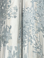 Close-up of Aspen Grove Blue Wallpaper by York Wallcoverings (60 SqFt), showing light fabric-like texture with blue and gray abstract floral patterns and a vertical seam where two sections meet.