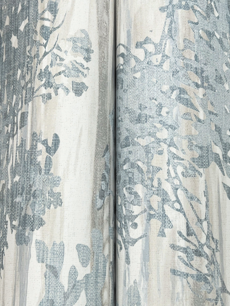Close-up of Aspen Grove Blue Wallpaper by York Wallcoverings (60 SqFt), showing light fabric-like texture with blue and gray abstract floral patterns and a vertical seam where two sections meet.