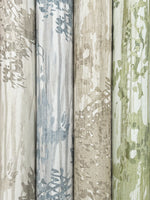 Four rolls of York Wallcoverings' Aspen Grove Grey Wallpaper (60 SqFt) arranged side by side, featuring an abstract botanical pattern in blue, gray, taupe, and green that resembles leaves or branches on textured backgrounds.