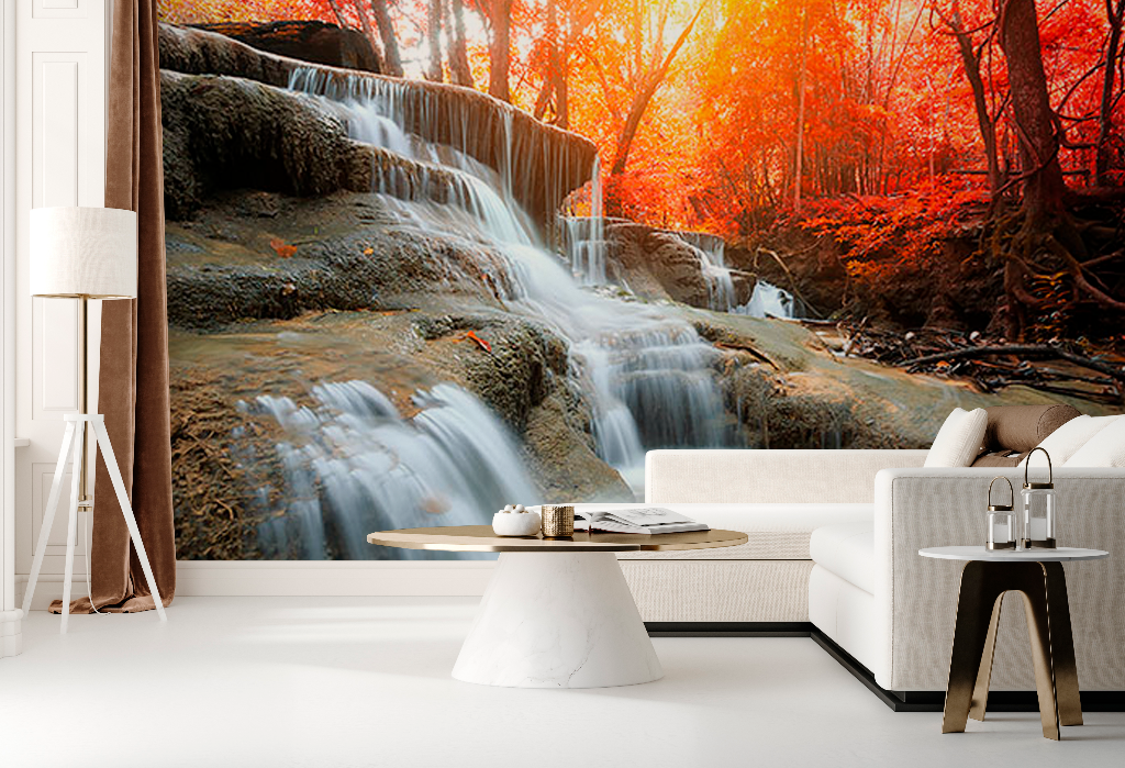 A stylish living room with a Decor2Go Wallpaper Mural of an Autumn Waterfall in a vibrant autumn forest, featuring a white sofa, a round coffee table, and a modern floor lamp.