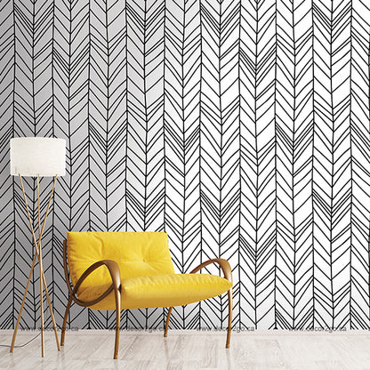 Black and white chevron geometrical wallpaper mural in the living room with yellow chair