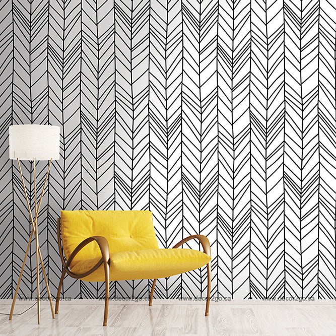 Black and white chevron geometrical wallpaper mural in the living room with yellow chair