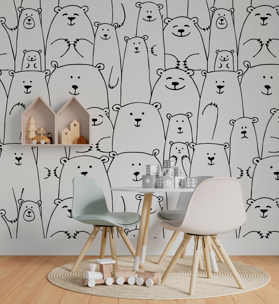 A children's playroom with a wall covered in a Decor2Go Wallpaper Mural Bear Family Black & White Wallpaper Mural. There are two modern chairs, a small table with toys, and a circular rug on a wooden floor.