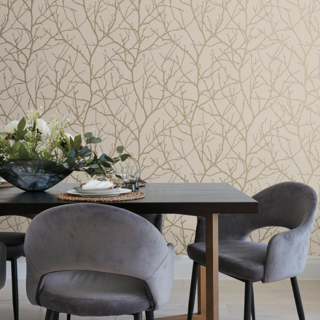 Dining Room - A Modern Metals Collection table comes with two gray chairs and a black metal frame, adorned with a floral centerpiece. The background features York Wallcoverings Beige & Gold Trees Silhouette Wallpaper, enhancing the cozy elegance of the setup