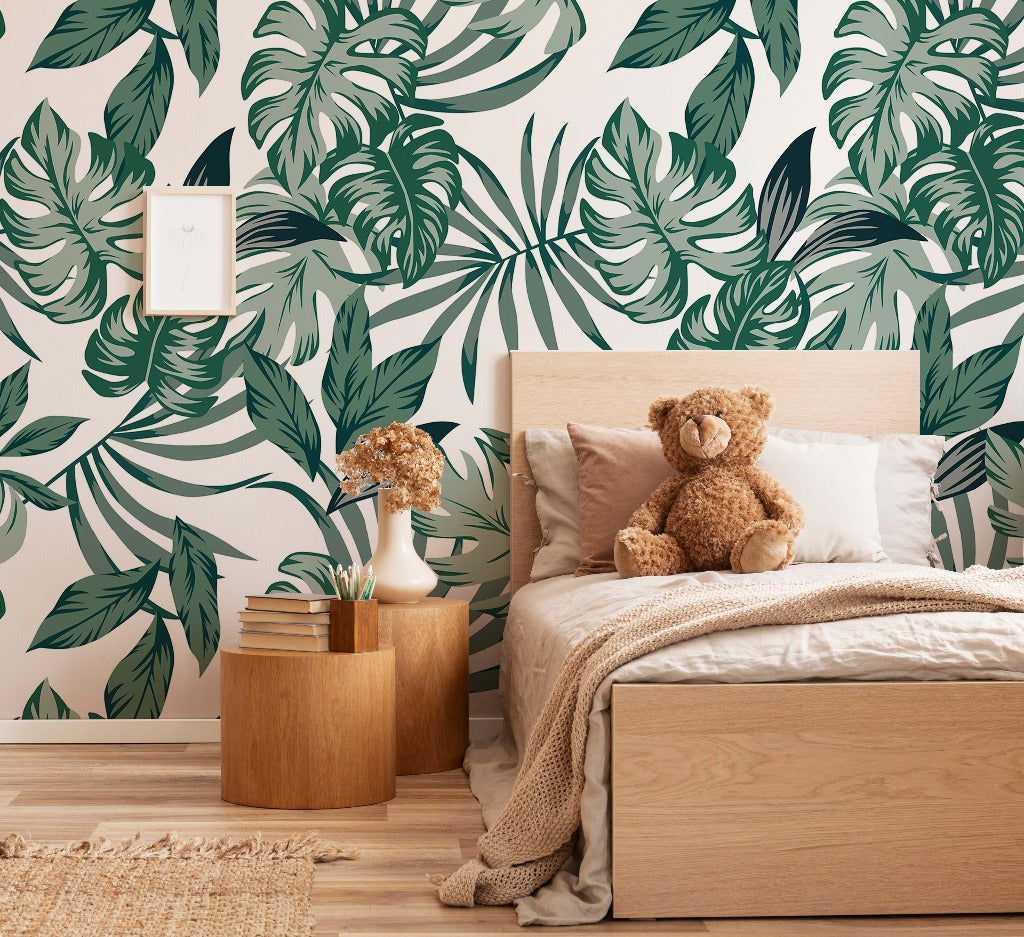 Bedroom - A cozy bedroom with Decor2Go Wallpaper Mural's Big Green Leaves Wallpaper Mural, featuring a wooden bed flanked by a nightstand with books, a teddy bear sitting on the bed, and a small framed poster on the wall