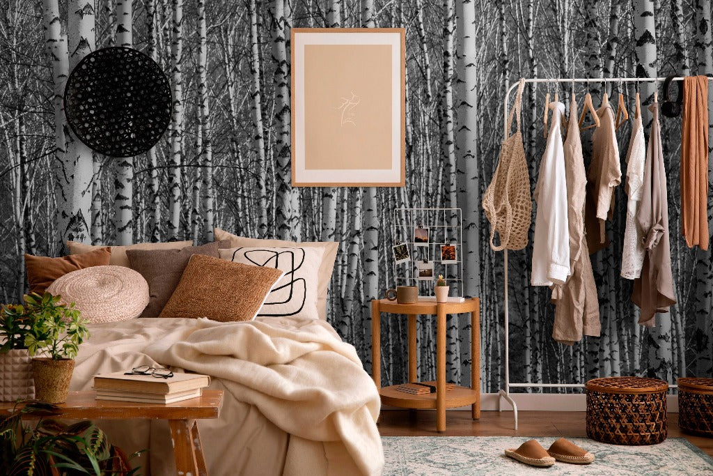A cozy bedroom corner with a bed against Decor2Go Wallpaper Mural, adorned with pillows and a beige throw. A clothes rack, side table, and wall art add to the rustic chic decor.