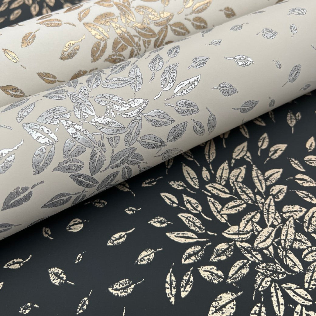 Discover the elegance of York Wallcoverings' Black & Gold Petite Leaves Wallpaper. Perfect for contemporary interiors, each roll features metallic finishes with silver leaves on light backgrounds or gold leaves on dark and light settings. Also, available as a flat sheet with gold leaf designs.