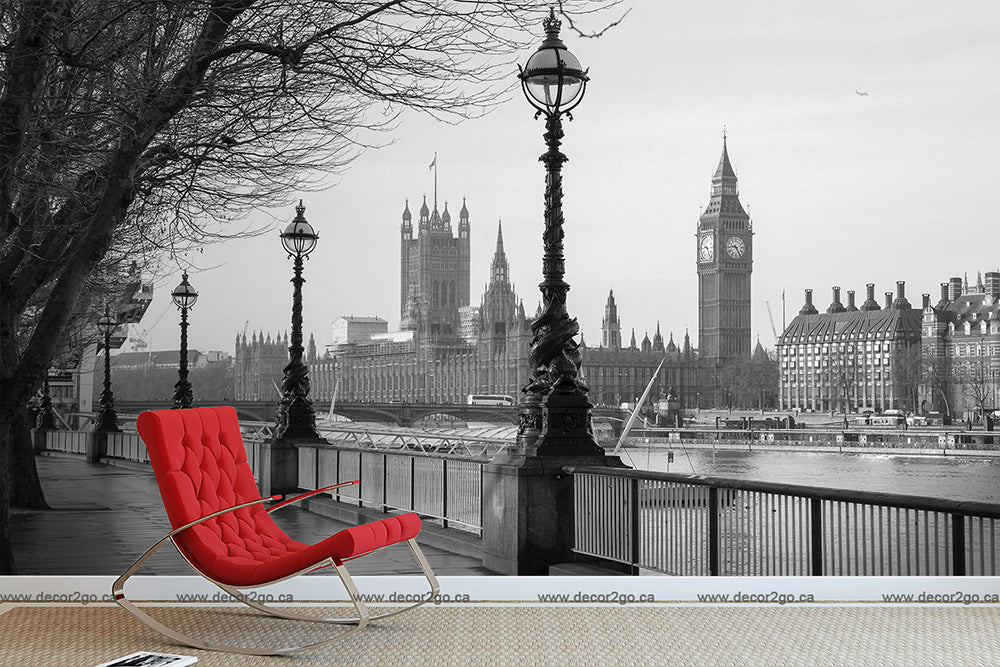 A **Black and White London Wallpaper Mural by Decor2Go Wallpaper Mural**, a nod to classic architectural design, adorns the wall. A modern red rocking chair is placed in front, adding a vibrant pop of color to the sophisticated setting.