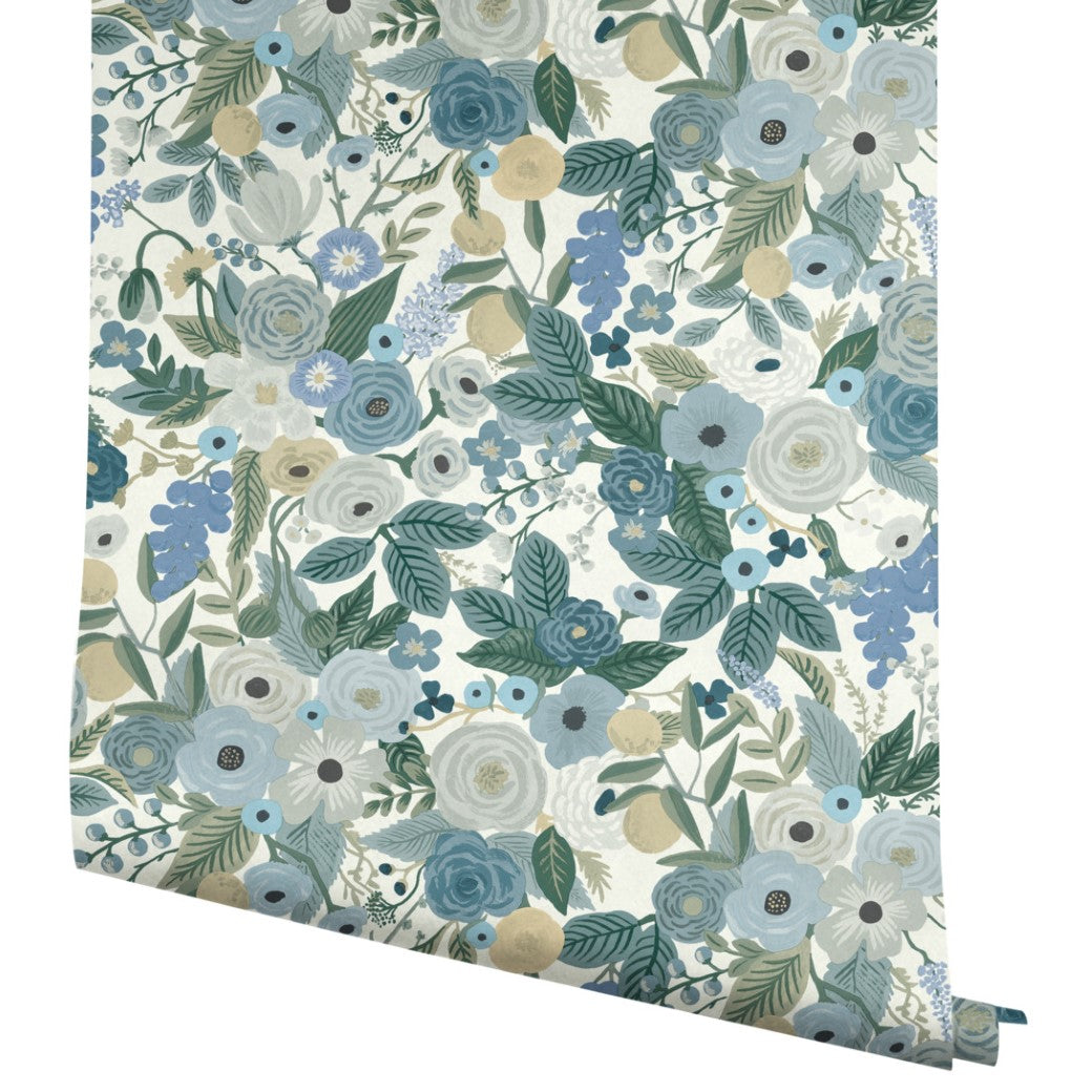 A roll of Blues Garden Party Wallpaper by York Wallcoverings features blue, green, white, and beige floral patterns on a light background; covers 60 SqFt.