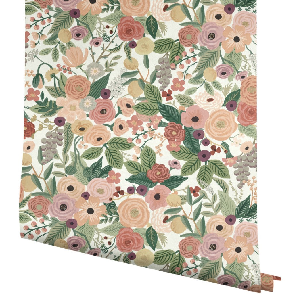 A roll of York Wallcoverings Burgundy Garden Party Wallpaper (60 SqFt) featuring a colorful floral pattern with pink, peach, and yellow flowers, green leaves, and purple berries on a crisp white background.