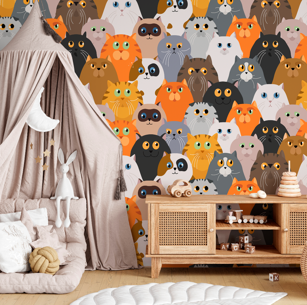 A cozy children's room with the whimsical Decor2Go Wallpaper Mural Cat Party wallpaper, featuring a draped tent-like play area, plush toys, and a wooden furniture unit with drawers.