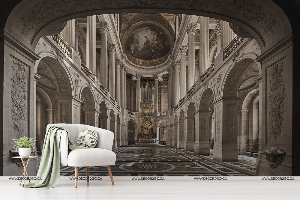 Living Room - An elegant modern living room setup featuring a white armchair, a throw blanket, and a side table with plant, against a large Cathedral Grande Wallpaper Mural by Decor2Go Wallpaper Mural of a grand, ornate historical interior.