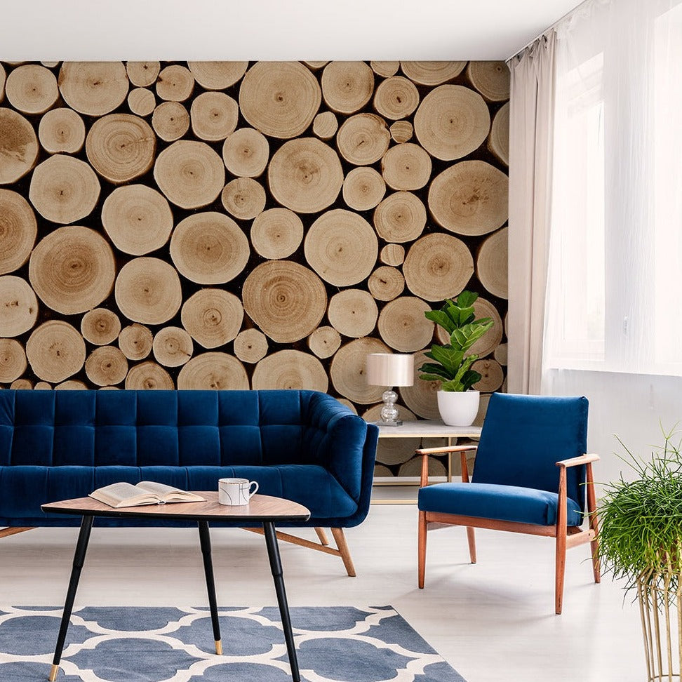 Living Room - A stylish living room featuring a dark blue sofa, matching armchair, and a wall decorated with Decor2Go Wallpaper Mural. An elegant table, potted plants, and light curtains enhance the space.