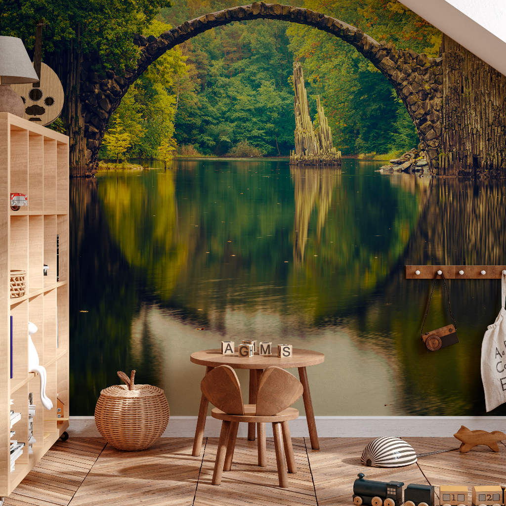 Kids Room - A cozy children's room with a Decor2Go Wallpaper Mural depicting a serene arch bridge over a reflective lake surrounded by autumn trees. There is a small wooden chair and toys neatly arranged on the hardwood floor.