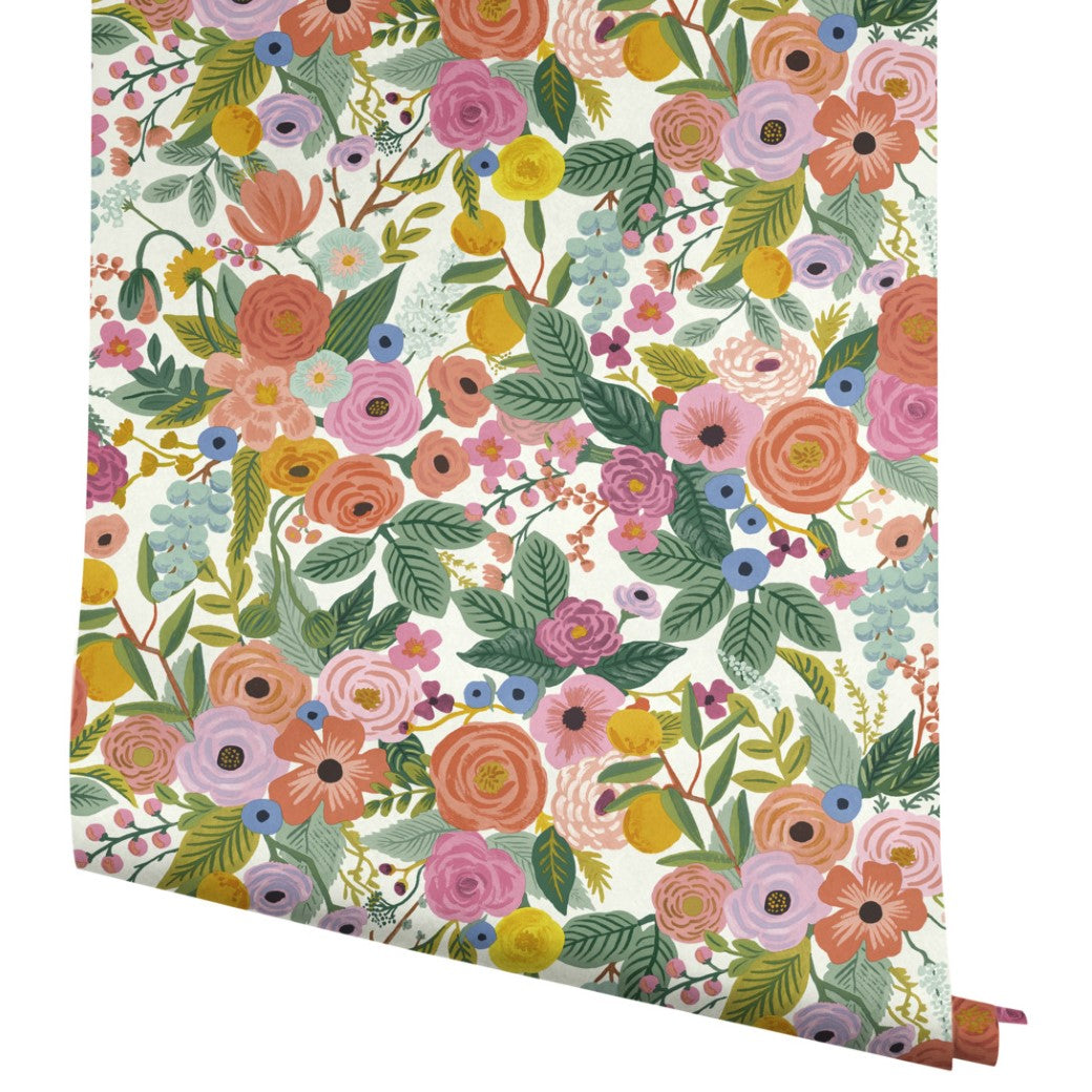 York Wallcoverings Coral/Orange Garden Party Wallpaper (60 SqFt) features a vibrant, dense floral pattern with pink, orange, yellow, and purple flowers, green leaves, and small berries on a white background.