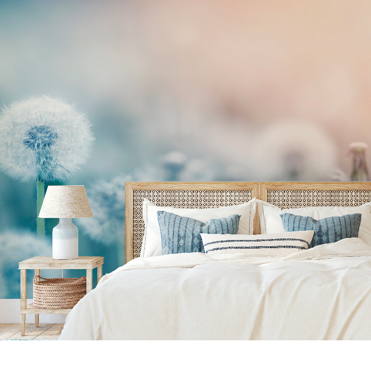 Bedroom - A serene bedroom featuring a large bed with white bedding and blue pillows, flanked by two wooden nightstands with lamps, set against a dreamy, pastel-colored Decor2Go Wallpaper Mural.