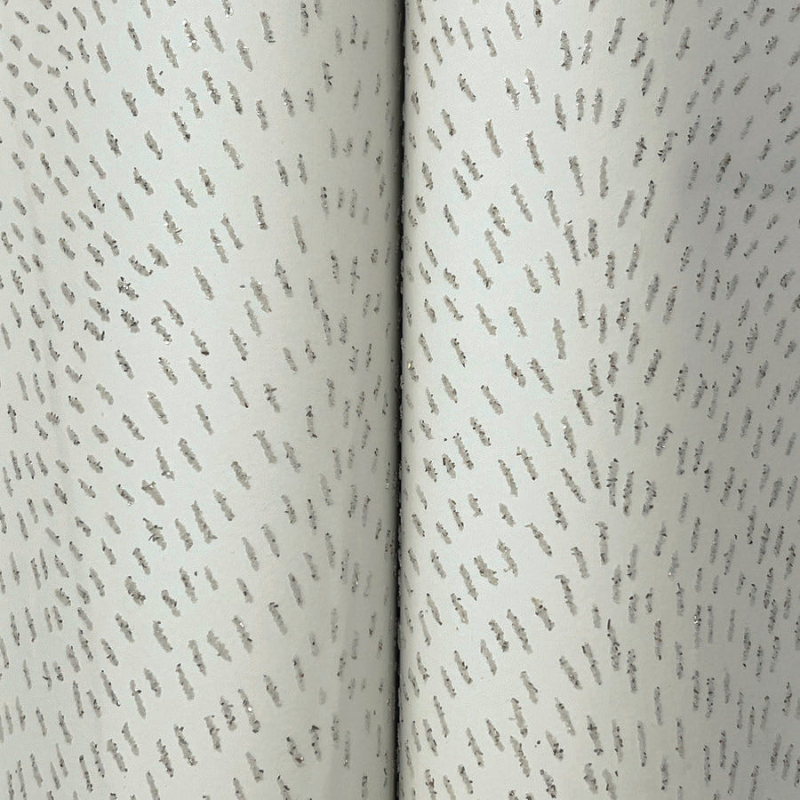 A close-up of York Wallcoverings Dew Drop Grey Wallpaper (60 SqFt), featuring a pale blue-grey glitter finish.