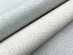 Close-up of two rolls of York Wallcoverings Dew Drop Beige Wallpaper (60 SqFt), featuring light gray and off-white tones with subtle scattered silver dashes that add a hint of shimmer and elegant glitter effect to your space.
