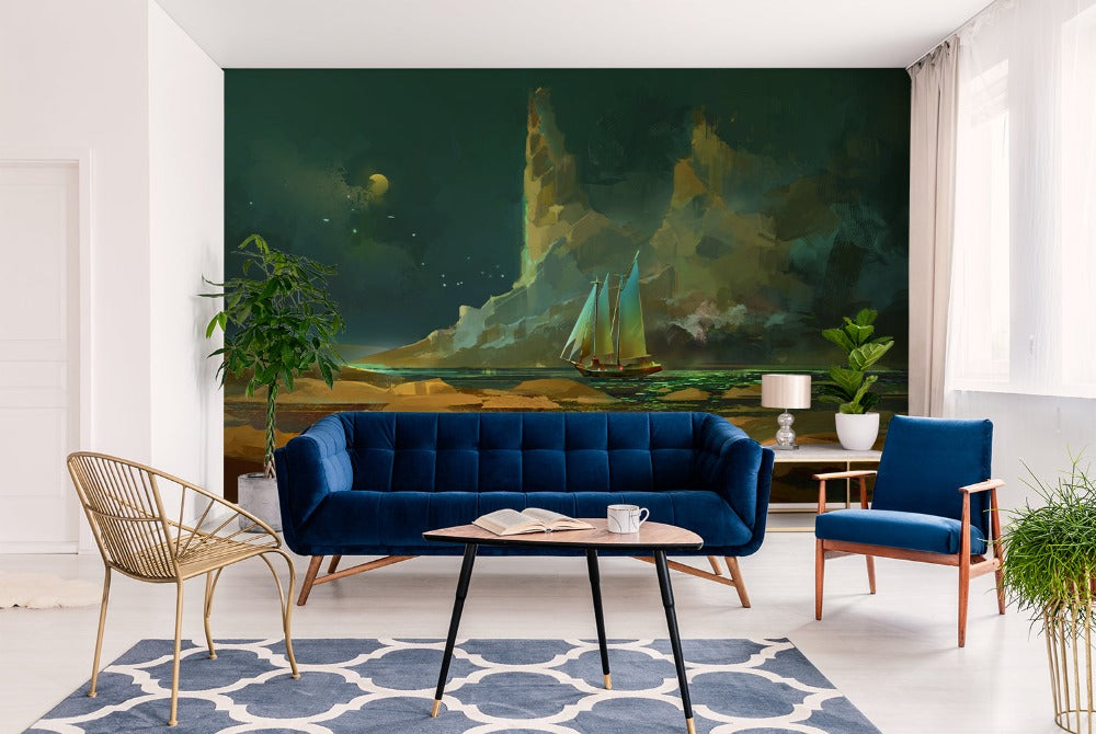 A modern living room with a large mural of the Decor2Go Wallpaper Mural featuring ships. Furniture includes a rustic wooden sofa, two blue armchairs, a gold chair, and a round black.