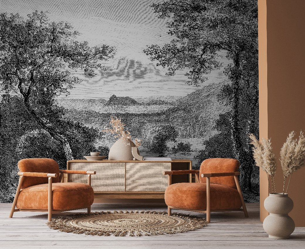 Living Room - A cozy living room features two burnt orange armchairs, a woven rug, and a sideboard with a vase of dried flowers. The backdrop is Decor2Go Winnipeg's Enchanted Grove Wallpaper Mural, depicting a lush landscape with trees and mountains that creates natural tranquility.